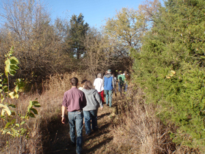 image of volunteers walking through trail