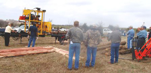 Image of conference participants view cedar eradication equipment