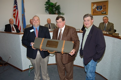 image of Jason Skaggs presenting John Groendyke with personalized gun case