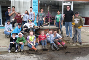 image of students posing with freshly planted tree