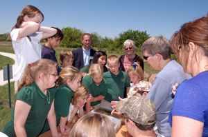 image of students gathered around Blue Thumb education station