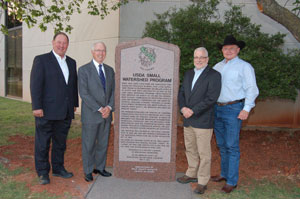 image of men standing near granit monument 