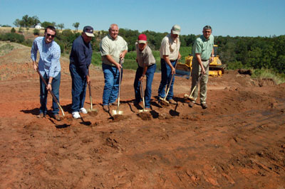 image of people digging dirt at groundbreaking